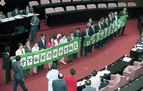 事件標題:民進黨立法院黨團再度動員要求院會處理「曾振農毆人事件」，民進黨立委並拉出布條、抗議及譴責暴力，國民黨立委則在前譏諷不以為然